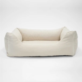 Hundebett EMMA Velours Greige M Graues Haustierbett mit erhöhten Rändern und einem weichen Innenraum, mit einem kleinen Etikett beschriftet "PAW."