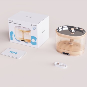 ROLA Smart Pet Wasserbrunnen in einem eleganten Design, mit einer Box, Benutzerhandbuch und USB-Kabel auf einem hellen Hintergrund.