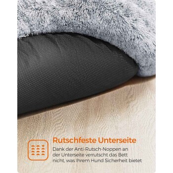 Graues flauschiges Hundebett mit schwarzer, punktierter rutschfester Unterseite auf Holzfußboden; sichtbarer deutscher Text 'Rutschfeste Unterseite'.