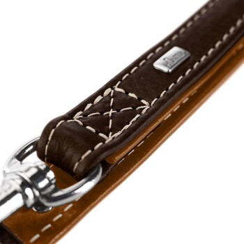 Nahaufnahme einer braunen Lederhundeleine mit weißen Nähten und einem silbernen Metallclip, die die hochwertige Verarbeitung zeigt.