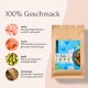 Haustierfutterverpackung, die Huhn, Lachs, Apfel und Leinsamen mit Vorteilen auf Deutsch zeigt: "100% Geschmack," "Hochwertige Proteine," und mehr.