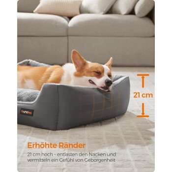 Ein entspannter Corgi schläft in einem gemütlichen grauen Haustierbett mit erhöhten Rändern, die Nackenstütze und ein Gefühl von Sicherheit bieten.