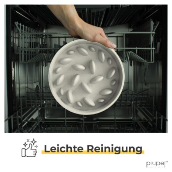 Eine Hand, die eine Futterschüssel mit einem strukturierten Boden in eine Geschirrspülmaschine stellt, begleitet von dem Text 'Leichte Reinigung' am unteren Rand.