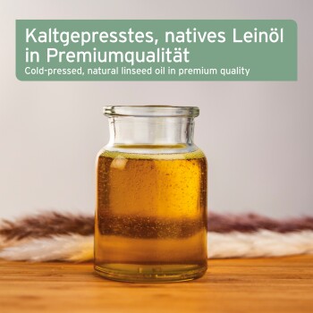 Glasgefäß mit Leinöl auf Holztisch; Text: 'Kaltgepresstes, natives Leinöl' und 'Cold-pressed, natural linseed oil'.