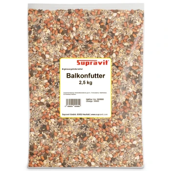 Nahaufnahme von gemischtem Vogelfutter mit Sonnenblumenkernen, Erdnüssen, Hafer und getrockneten Fruchtstücken.