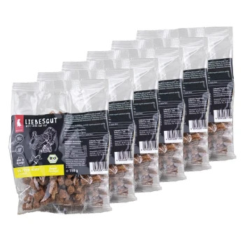 Sechs durchsichtige Plastikbeutel mit braunen Leckerlis, beschriftet „LIEBESGUT“, „150 g“ sichtbar.
