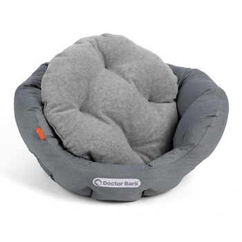 Ein gemütliches, rundes Haustierbett aus grauem Stoff mit einem plüschigen, weichen Innenraum, mit dem Logo "Doctor Bark" auf der Vorderseite.