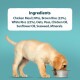 A yellow Labrador puppy eats from a metal bowl; ingredients listed above include chicken meal, rice, oats, peas, oils, seaweed, and minerals.