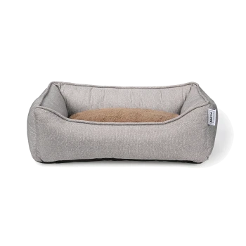 Lit pour animal de compagnie gris avec un coussin marron doux au centre, présentant des côtés surélevés pour le confort et le soutien.