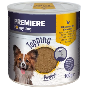 Ein Behälter mit Premiere-Hundetopping-Pulver, auf dem ein lächelnder Hund abgebildet ist. Das Etikett lautet "Hühnermagen mit Kokosnuss" und "100g."
