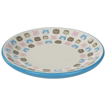 A shallow pet bowl featuring a colorful border of cat faces in pink, blue, and brown against a cream background.