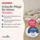 Eine Person hält eine Dose "Erste Hilfe Wundsalbe" für Haustiere, mit einem Hund im Hintergrund. Text: "Schutz und Pflege, Optimale Wundversorgung."