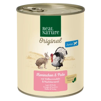 Dose Real Nature Hundefutter mit der Aufschrift 'Junior', die Illustrationen eines Kaninchens und einer Pute zeigt, mit dem Text 'Kaninchens & Pute' und aufgelisteten Zutaten.