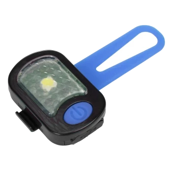 Une lumière de sécurité pour animaux de compagnie noire et bleue avec un objectif à motif de diamant et un interrupteur bleu, conçue pour la visibilité lors des promenades.