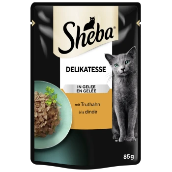 Sheba Delikatesse Katzenfutterbeutel mit einer grauen Katze und einer Schüssel mit Fleisch in Gelee, beschriftet mit "mit Truthahn à la dinde," 85g.
