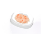 Assiette ovale blanche contenant de la nourriture humide rose effilochée pour animaux avec morceaux de crevette dans un bouillon sur fond blanc