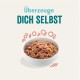 Schüssel mit Haustierfutter mit einer strukturierten Mischung, umgeben von verspielten grafischen Elementen, mit dem Text 'Überzeuge DICH SELBST.'