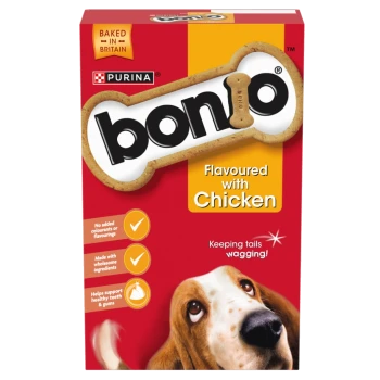 Purina Bonio dog biscuit box, red/yellow with bone logo, text "Flavoured with Chicken" and "Baked in Britain", dog photo