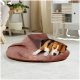 Ein gemütliches braunes Haustierbett auf einem hellen Boden, mit einem Beagle, der bequem darauf ruht.