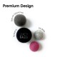 Vier Filzbälle (dunkelgrau, schwarz, hellgrau, rosa) vor weißem Hintergrund mit dem Text 'Premium Design' und schwarzem Ball mit Stickerei 'LUCY BALU'.