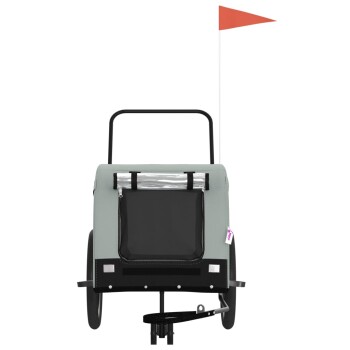 Haustieranhänger mit einem grauen Stoffbezug, einem schwarzen Stauraum und einer Sicherheitsflagge, entworfen für den Transport von Haustieren.