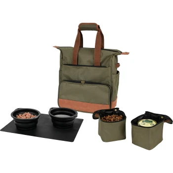 A green and brown pet travel bag with two collapsible black bowls on a black mat, and two small containers with pet food.