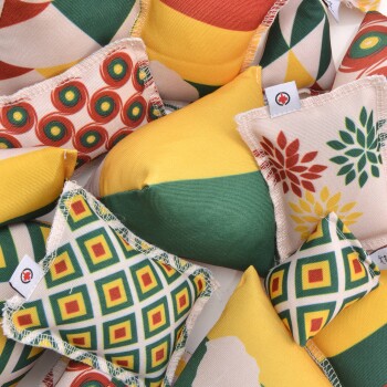 Bunte Haustierspielzeuge in verschiedenen Formen und Mustern, einschließlich geometrischer Designs und floraler Motive, zusammen verstreut.