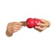 A person holds a red KONG dog toy while inserting a KONG-shaped treat into it, showcasing interactive pet play.