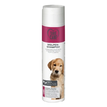 Bouteille de shampooing pour chiots "Take Care" avec une étiquette rose comportant du texte en plusieurs langues, indiquant qu'il est 100% végétalien.
