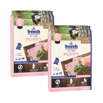 Zwei 7,5 kg Säcke Bosch Welpenfutter in Pink und Weiß, die Kroketten und Fleisch zeigen, mit den Aufschriften "28% Protein" und "17% Fett."