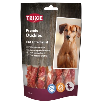 Packung von TRIXIE Premio Duckies Hundeleckerlis mit Entenbrust, mit einem Holz-Hintergrund und Symbolen, die 0% Zuckerzusatz und glutenfrei anzeigen.