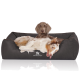 Ein gemütliches Hundebett in Dunkelbraun mit einem Logo, das "KNUFFELWUFF" liest, mit einem entspannten Australian Shepherd, der bequem liegt.