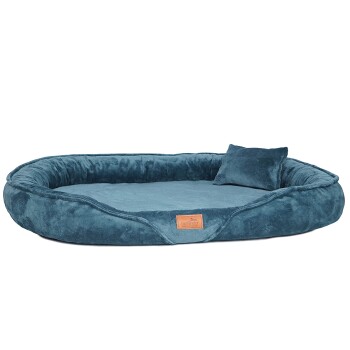 Teal Plüsch-Hundebett mit erhöhten Rändern, weicher Oberfläche, kleinem passenden Kissen und einem beige "tierlando" Etikett.
