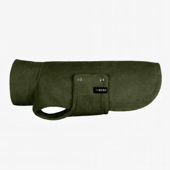 Ein stilvoller Hund, der einen weichen, olivgrünen Fleece-Mantel mit hohem Kragen und einer Seitentasche trägt, vor einem schlichten Hintergrund stehend.