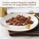 Zerkleinertes Nassfutter mit Erbsen und Karotten auf weißem Teller; Text: 'Erlesene, delikate Häppchen...'
