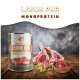 Dosenfutter für Haustiere mit der Aufschrift "Lamm Pur" von Wildfang, mit rohen Lammstücken und Innereien auf einer Holzoberfläche, mit dem Text "MONOPROTEIN" darüber.