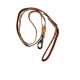 Brown leather dog leash with patterned trim, metal clasp and orange plastic slider, loop handle on black background.