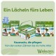 Whimzees Hundezahnpflege-Leckerlis (grüne Dose und Tüten) mit deutscher Überschrift 'Ein Lächeln fürs Leben' und Markenlogo.