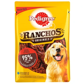 Ein Golden Retriever neben einer Tüte Pedigree Ranchos Originals Leckerlis, mit einem gelben Hintergrund und rotem Logo, das "95% Fleisch" hervorhebt.