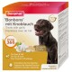 Verpakking van Beaphar 'Bonbons' mit Knoblauch hondenkoekjes met een blije zwarte hond, knoflook en voedingsvoordelen zoals Omega 3&6.