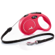 A bright pink retractable dog leash with a black strap and silver clip, featuring a silhouette of a dog and the text "MADE IN GERMANY."