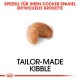 Kibble in Form einer Niere, beschriftet mit "Maßgeschneiderte Kibble", mit deutschem Text, der besagt: "Spezial für Ihren Cocker Spaniel entwickelte Krokette."
