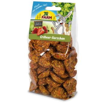 A clear plastic bag filled with heart-shaped pet treats labeled "Erdbeer-Herzchen" from JR FARM, featuring a cartoon rabbit and strawberries.