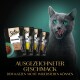 Eine graue Katze mit grünen Augen leckt sich die Lippen vor Sheba Katzenfutterbeuteln mit dem Text "Ausgezeichneter Geschmack."