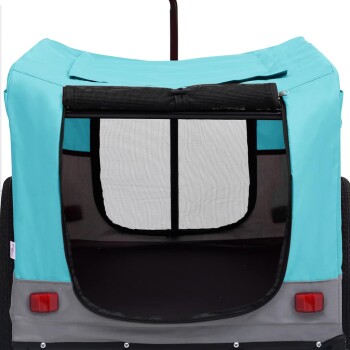 Ein türkisfarbener Haustieranhänger mit einer Netzöffnung auf der Rückseite, ausgestattet mit einem stabilen Rahmen und grauem Boden, entworfen für den Transport von Haustieren.