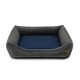 Graues Haustierbett mit einem marineblauen Kissen, das erhöhte Seiten für Komfort und ein kleines Lederetikett an der Seite hat.