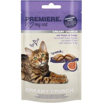 A Bengal cat rests next to a "Premiere I Love My Cat" Creamy Crunch treats package, showcasing chicken and fig flavor.