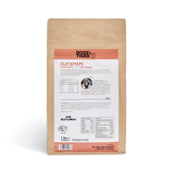 Hundfutterverpackung mit der Aufschrift "Flitzpiepe", die Truthahn und Lachs mit Gemüse enthält. Nährwertinformationen und Fütterungshinweise sind sichtbar.