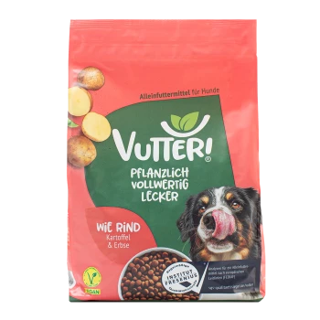 Roter und grüner Beutel Vutter! veganes Hundefutter mit Kartoffeln, Erbsen und einem Hund, der sich die Nase leckt, auf der Vorderseite.