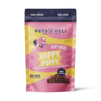 Junior Soft Bites Happy Puppy 300g Eine bunte Haustierfuttertüte mit der Aufschrift "Happy Puppy Soft Bites" für Hunde, die einen Cartoon-Welpen zeigt und angibt, dass sie getreidefrei und zuckerfrei ist.